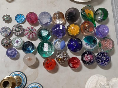 Lot 21 - Thirty-one glass paperweights.