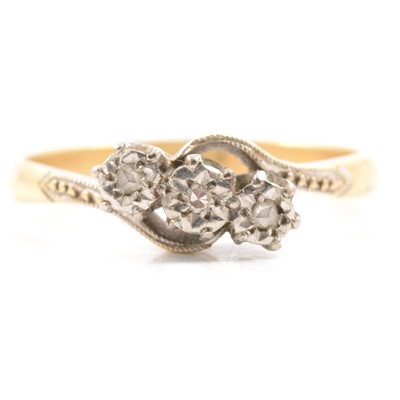 Lot 11 - A diamond three stone crossover ring.