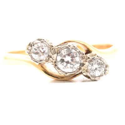 Lot 10 - A diamond three stone crossover ring.