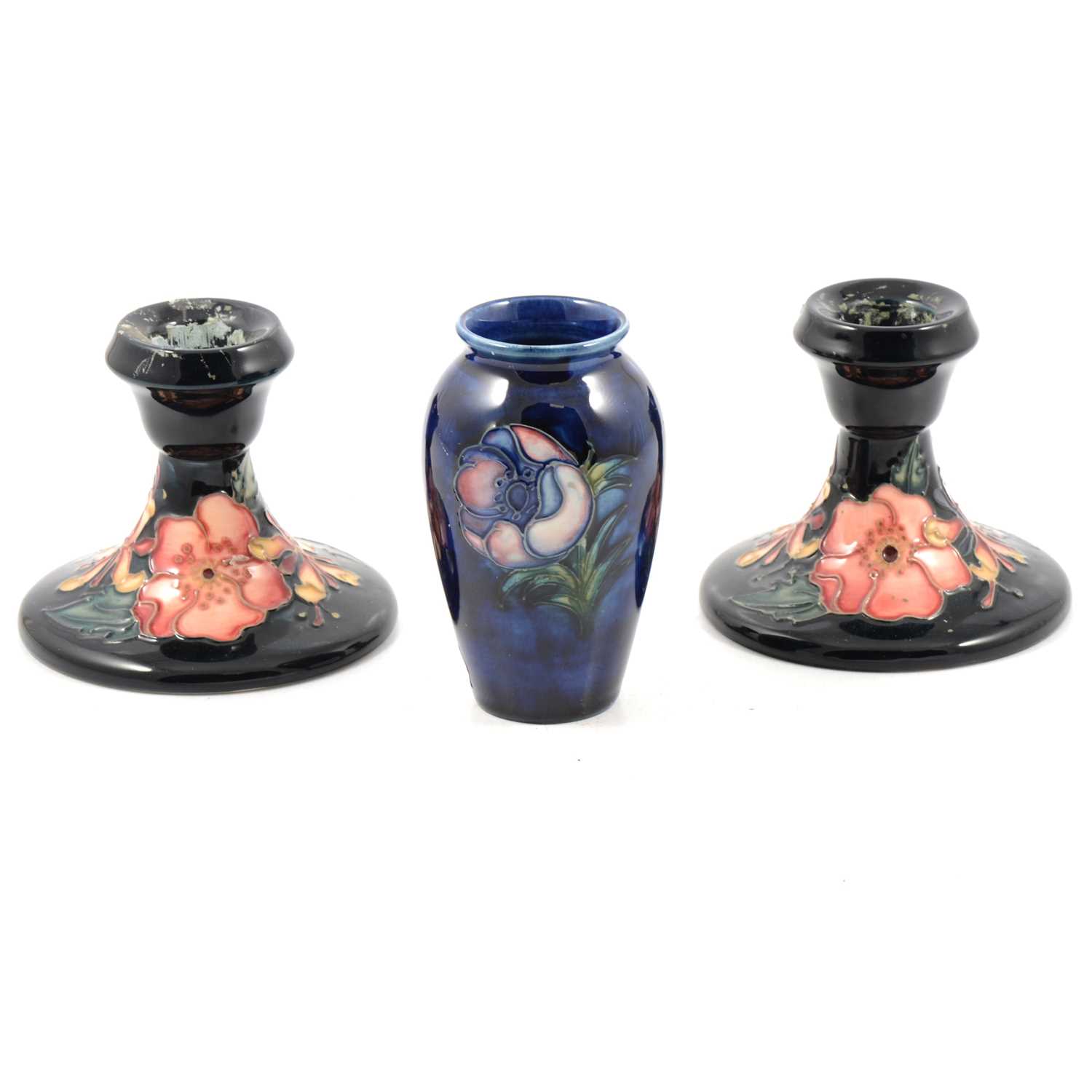 Lot 26 - A pair of Moorcroft Pottery dwarf candlesticks, 'Oberon' pattern, and a small vase, 'Poppy' pattern.