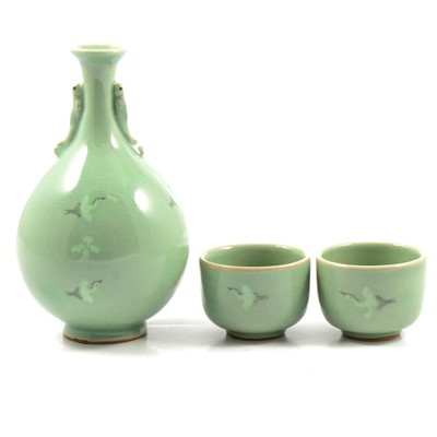 Lot 6 - Korean pottery two sake cups and bottle, celadon glaze with flying cranes