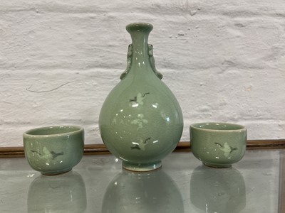 Lot 6 - Korean pottery two sake cups and bottle, celadon glaze with flying cranes
