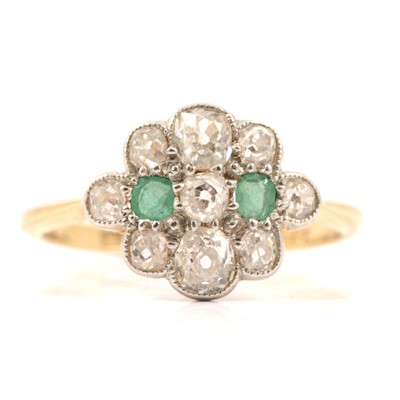 Lot 26 - An emerald and diamond cluster ring.