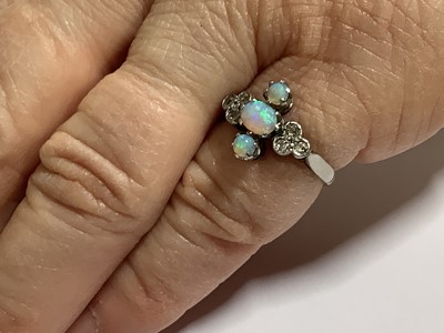 Lot 70 - An opal and diamond ring.