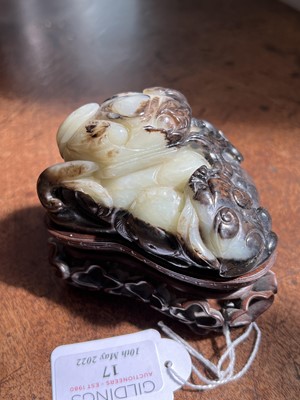 Lot 17 - Chinese green and russet jade carving of a recumbent lion