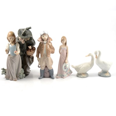 Lot 19 - Seven Lladro figurines, two Nao swans and an Aynsley table decoration.