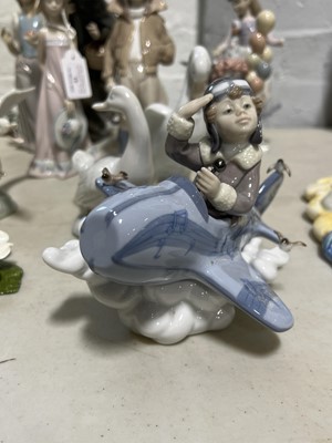 Lot 19 - Seven Lladro figurines, two Nao swans and an Aynsley table decoration.
