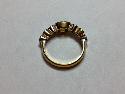 Lot 27 - A peridot and diamond half hoop ring.