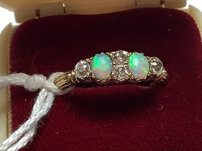 Lot 51 - An opal and diamond half hoop ring.