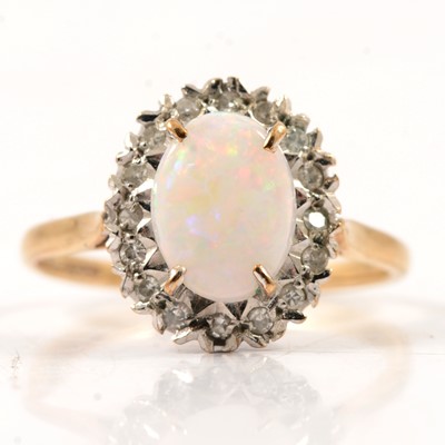 Lot 50 - An opal and diamond oval cluster ring.