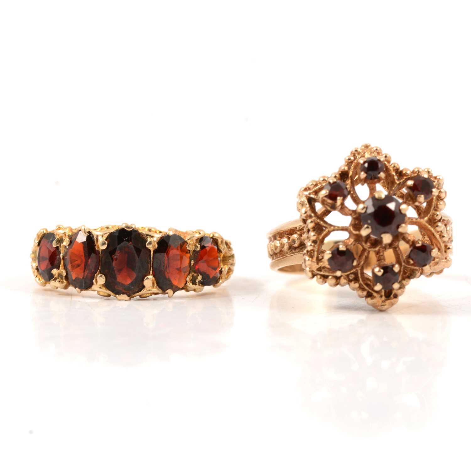 Lot 72 - Two garnet dress rings.