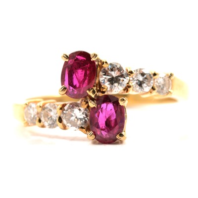 Lot 28 - A ruby and diamond crossover ring.