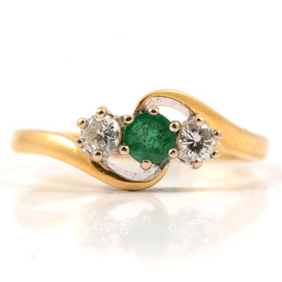 Lot 25 - An emerald and diamond three stone ring.