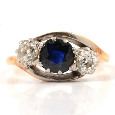 Lot 35 - A sapphire and diamond three stone ring.