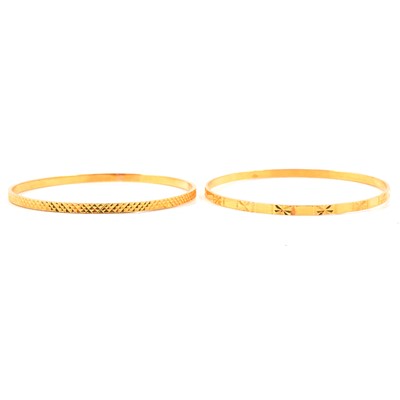 Lot 139 - Two yellow metal slave bangles.