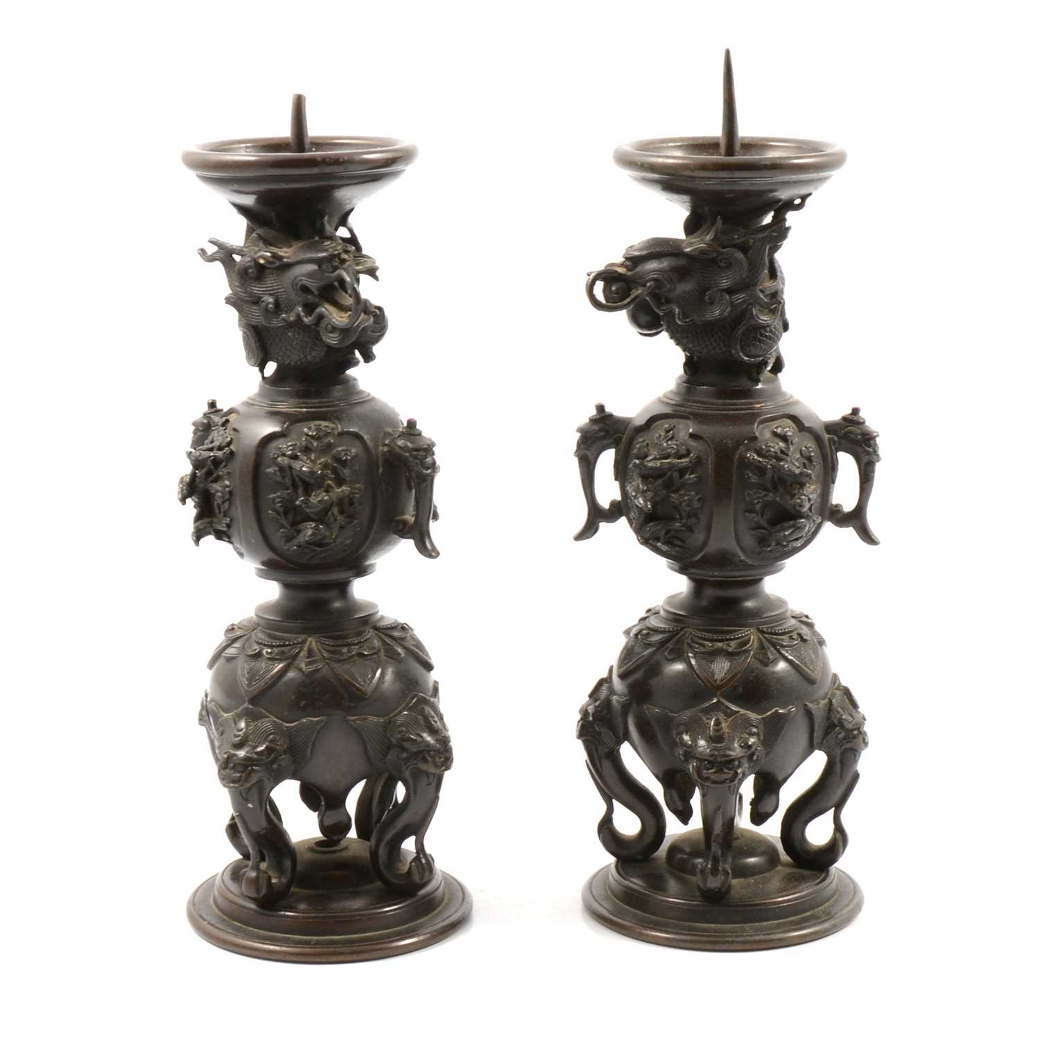 Lot 129 - Pair of Chinese patinated metal pricket candlesticks