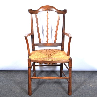 Lot 396 - Elm rush-seated elbow chair, wavy slat back