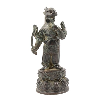 Lot 103 - An Oriental patinated bronze dragon deity