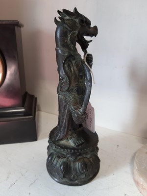 Lot 103 - An Oriental patinated bronze dragon deity