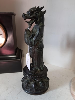 Lot 103 - An Oriental patinated bronze dragon deity