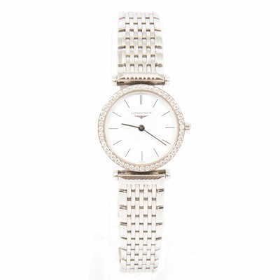 Lot 338 - Longines - a lady's steel watch with a diamond bezel.