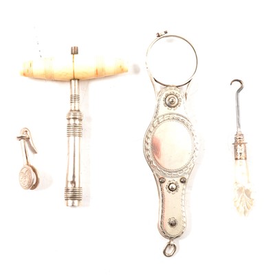 Lot 406 - A white metal retractable monocle, glove button hook, personal napkin holder, pocket corkscrew.