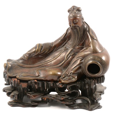 Lot 167 - A Chinese bronze figure of dignitary, reclining