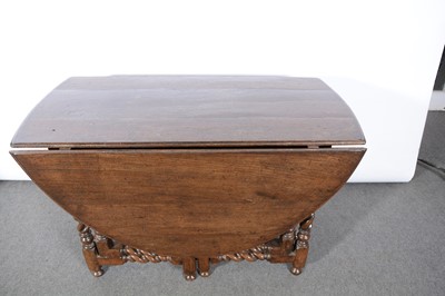 Lot 392 - An oak gateleg dining table