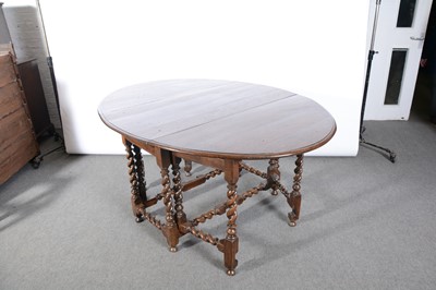 Lot 392 - An oak gateleg dining table