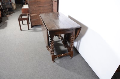 Lot 392 - An oak gateleg dining table