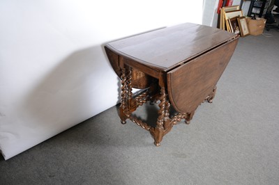 Lot 392 - An oak gateleg dining table