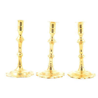 Lot 3 - A pair of George II brass candlesticks, and another similar