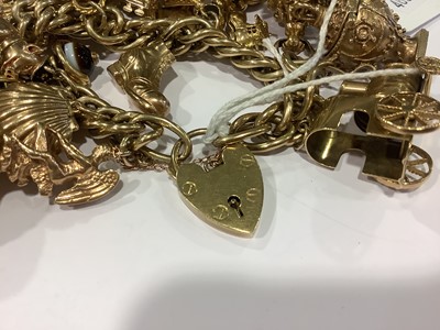 Lot 174 - A 9 carat yellow gold bracelet with charms.