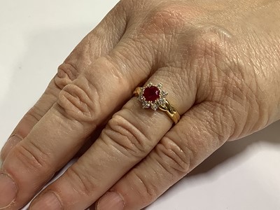 Lot 350 - A ruby and diamond circular cluster ring.