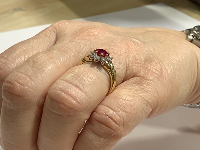 Lot 350 - A ruby and diamond circular cluster ring.