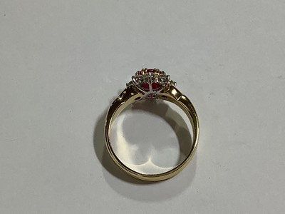 Lot 350 - A ruby and diamond circular cluster ring.