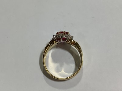 Lot 350 - A ruby and diamond circular cluster ring.