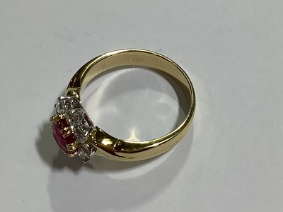 Lot 350 - A ruby and diamond circular cluster ring.