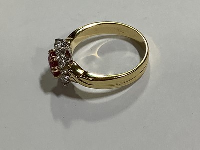 Lot 350 - A ruby and diamond circular cluster ring.