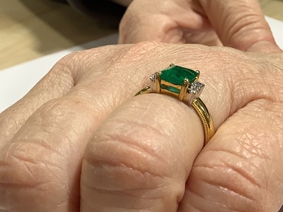 Lot 62 - An emerald and diamond ring.