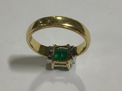 Lot 62 - An emerald and diamond ring.