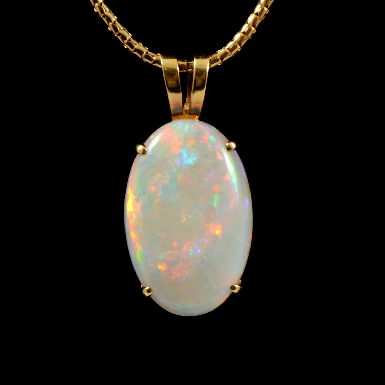Lot 215 - An oval cabochon cut opal pendant and chain.