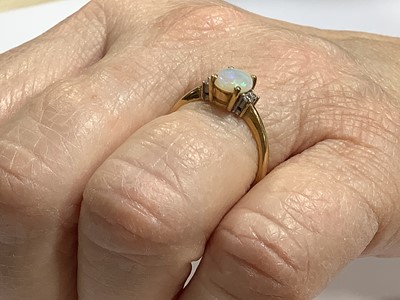 Lot 71 - An opal and diamond dress ring.