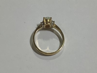 Lot 71 - An opal and diamond dress ring.