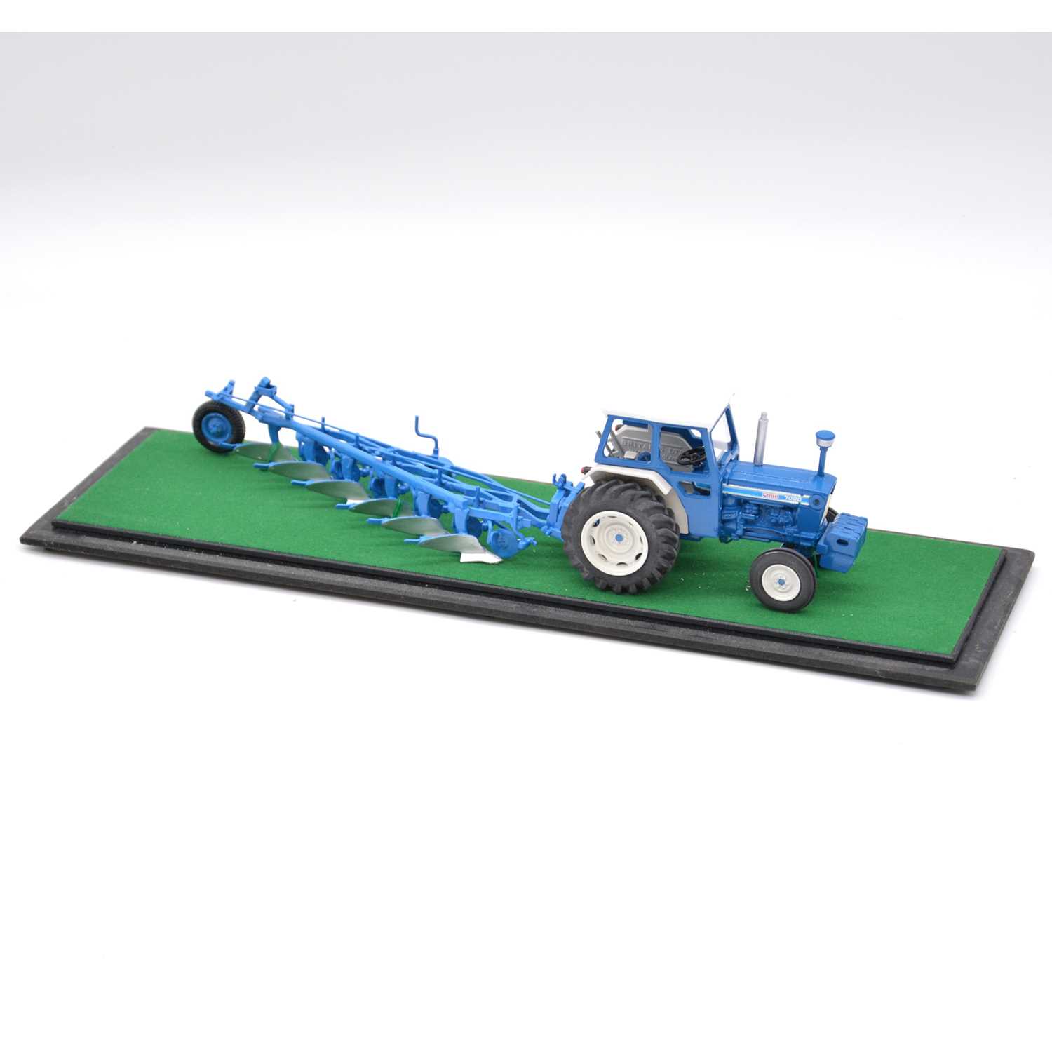 Lot 316 - Britains farm model Ford 7000 tractor, with plough, in custom display case.