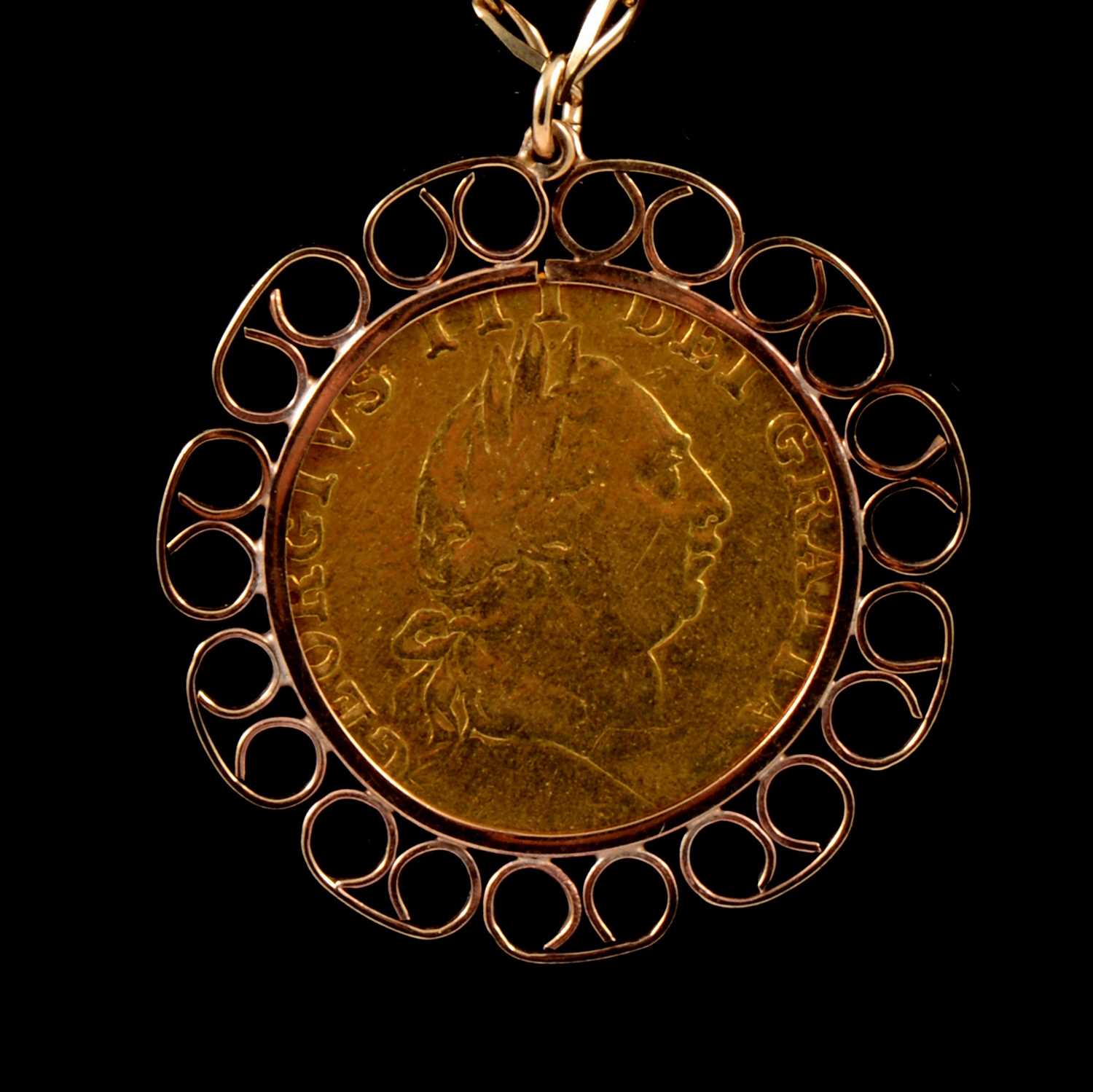 Lot 114 - A Gold Spade Guinea pendant and chain.