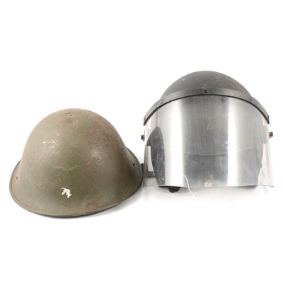 Lot 263 - A collection of military helmets, hats, trench tool.