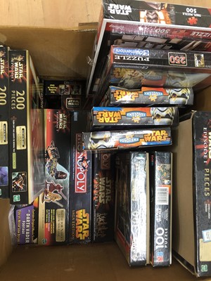 Lot 437 - Star Wars games and puzzles, two boxes full including two Star Wars Monopoly editions etc