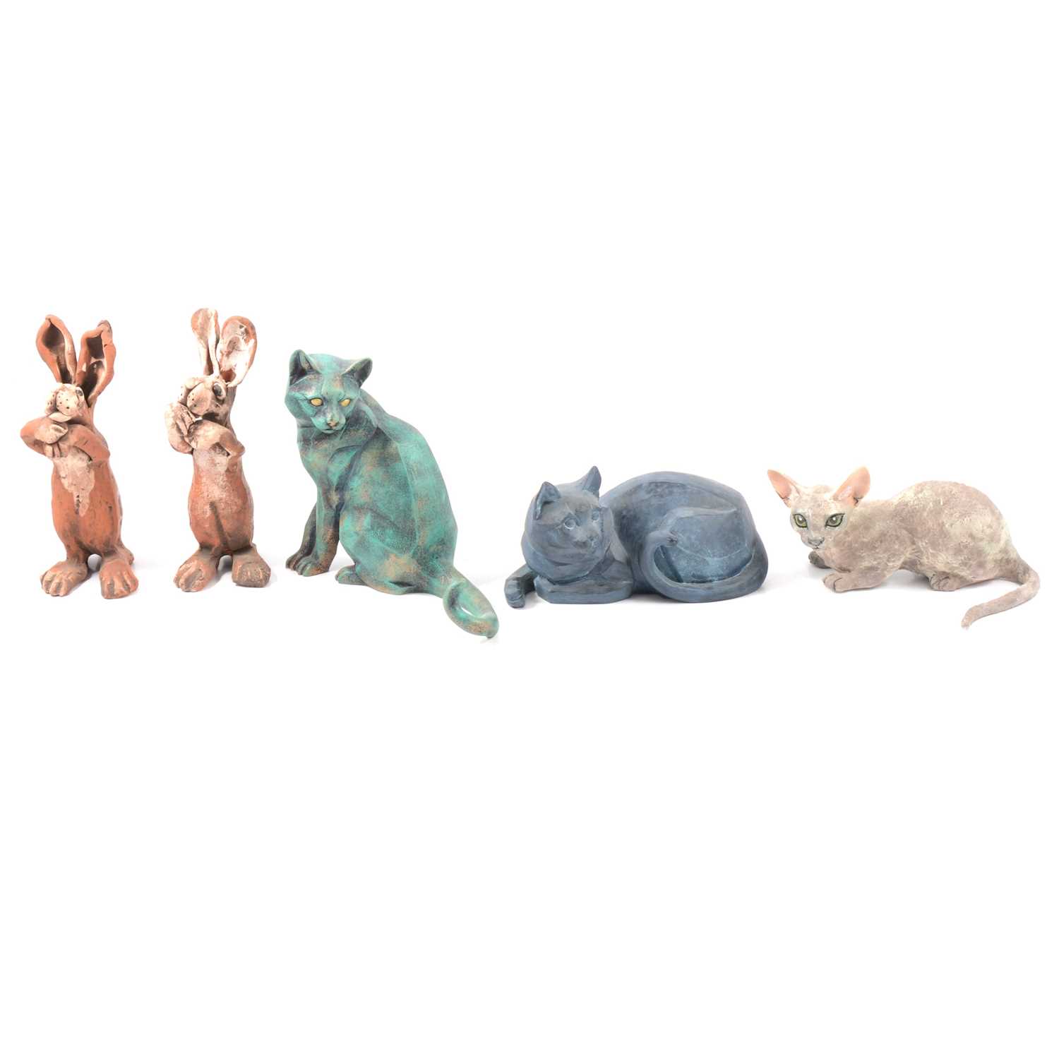 Lot 32 - Four cats figurines and two hare figurines.