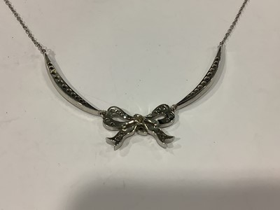 Lot 208 - A diamond bow design necklace.